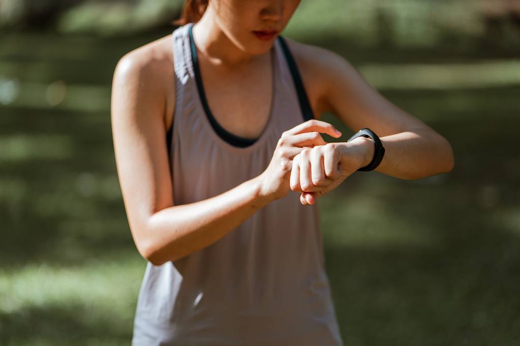 woman checking fitness tracker